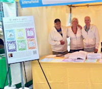 three people standing in front of a tent